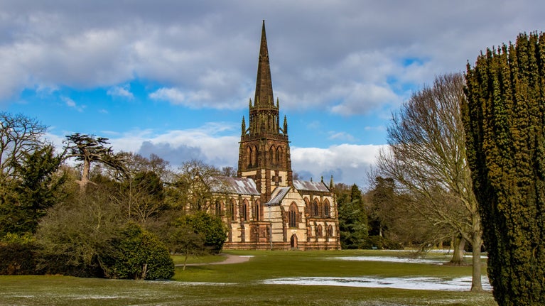 The Chapel standing in the Pleasure Grounds surrounded by trees and grass with frost on the ground